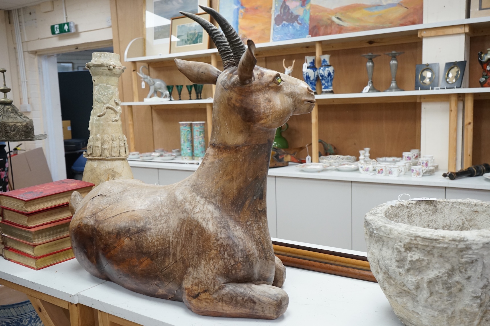 A large Vietnamese hardwood model of a recumbent goat, 78cm wide
